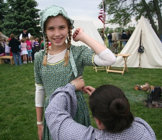 Carol performs emergency repairs to student's costume